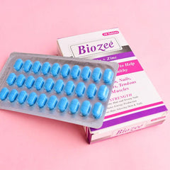 Biozee tablets with zinc for wellness, blue pills and packaging on pink background, Phlox supplements